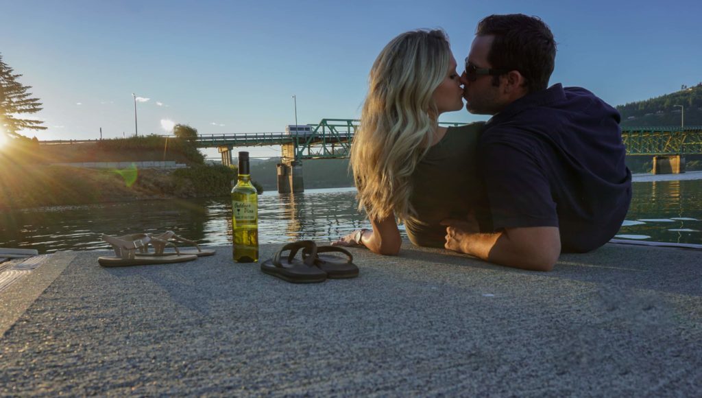 couple drinking wine by the columbia river gorge in hood river oregon