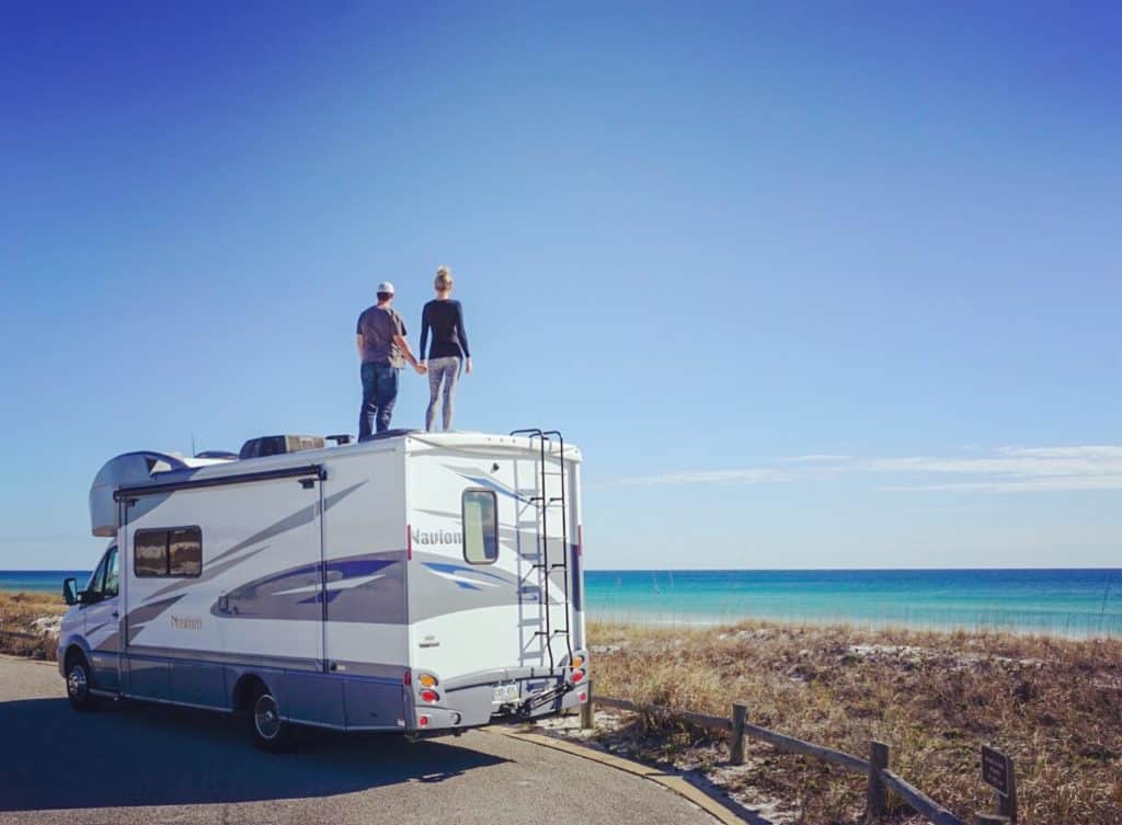 Couple on Roof of RV overlooking the ocean