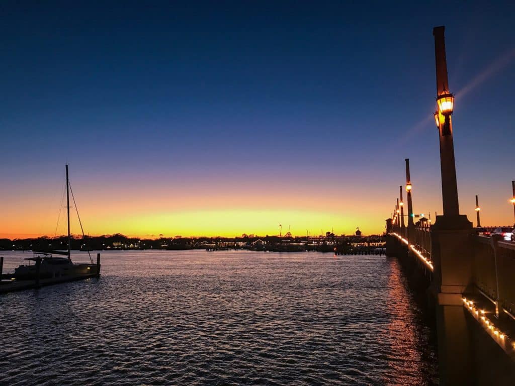 St. Augustine Bridge of Lions at sunset with sail boat