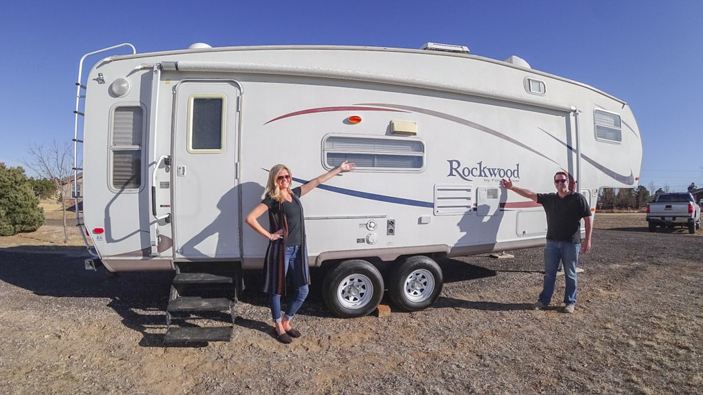 Young Couple standing in front of RV 