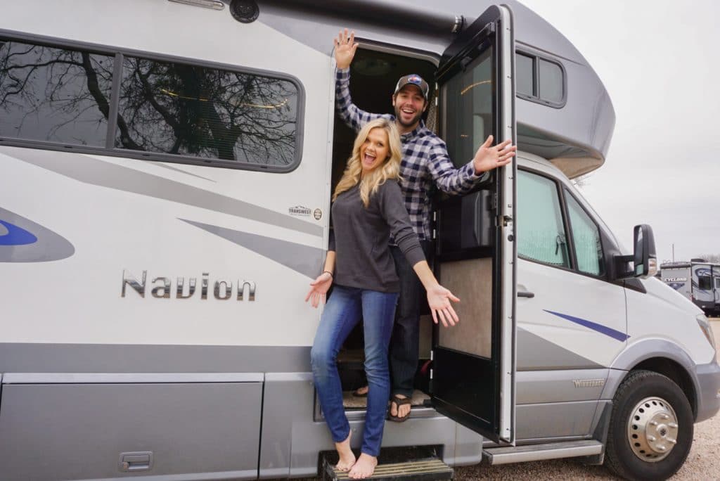 Young couple standing in RV excited