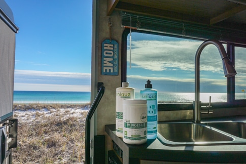 Unique Camping RV Digest It products on the counter of an RV with ocean views