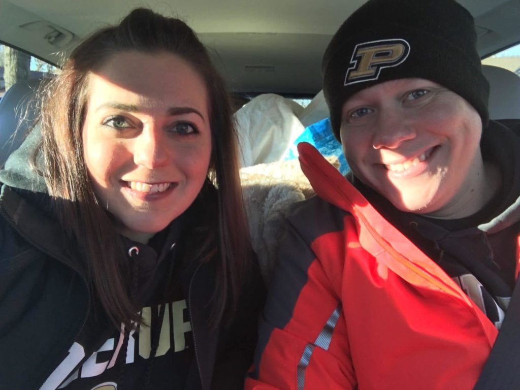 couple in a car packed for a road trip