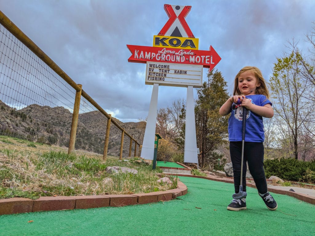 toddler miniature golfing at KOA campground