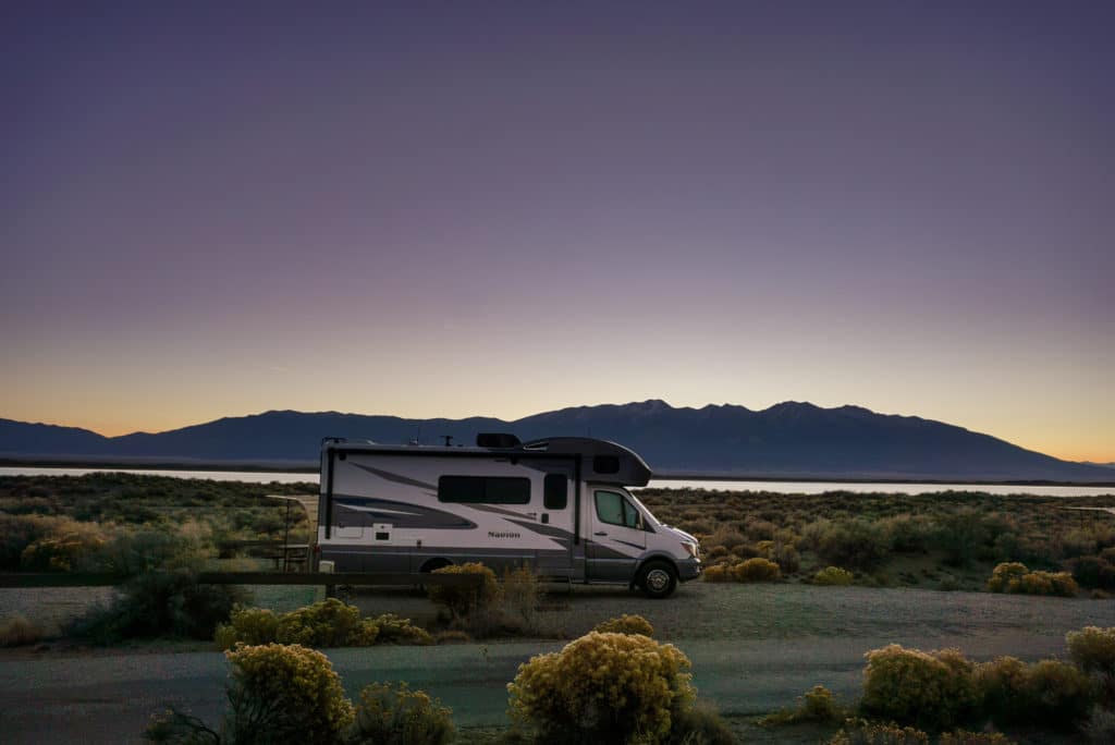 rv motorhome by lake in Colorado at sunset