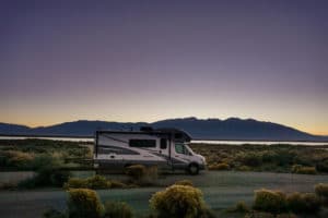 rv motorhome by lake in Colorado at sunset