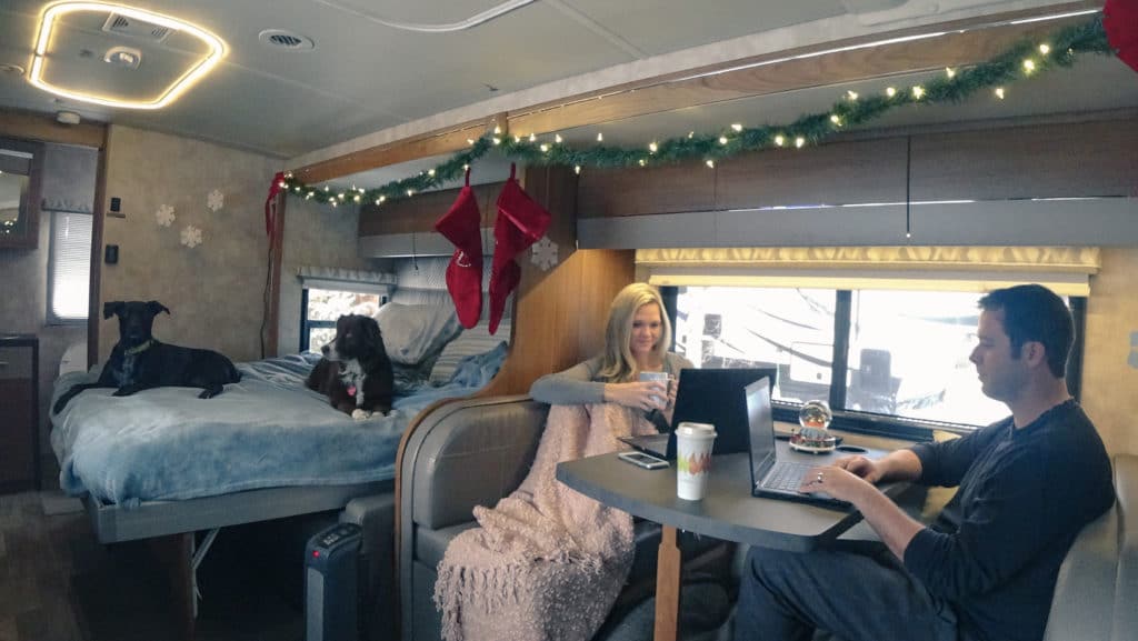 couple working on computers in an RV motorhome