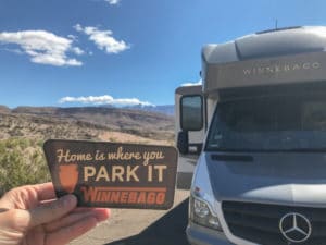 RV motorhome with sticker that says home is where you park it