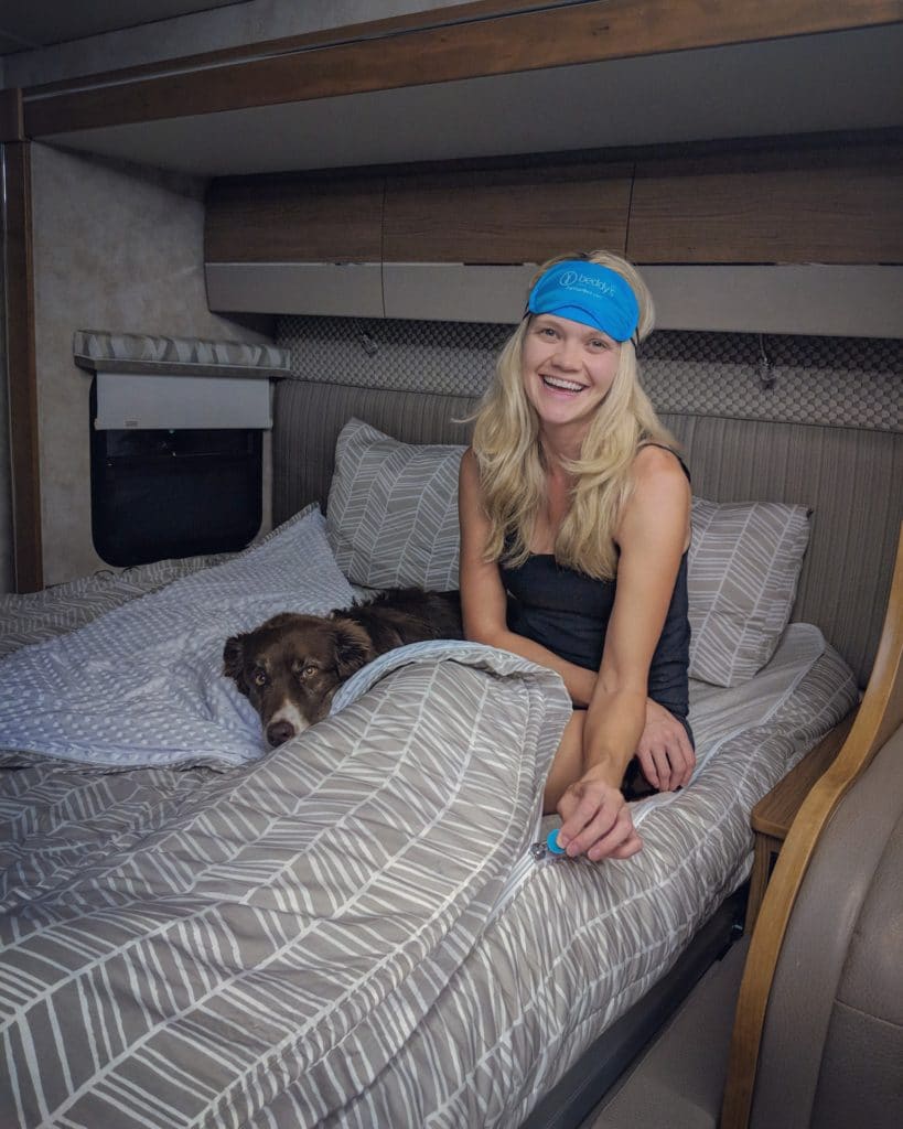 woman on bed in rv with sleep mask and beddy's bedding