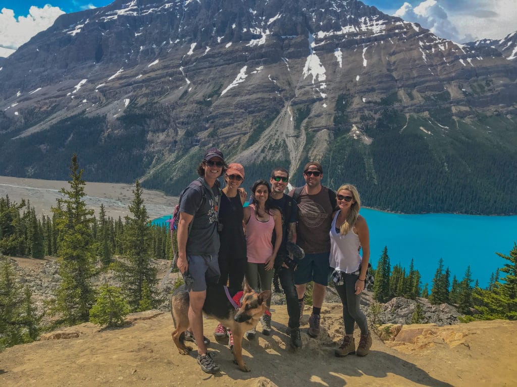 group of friends smiling while hiking near peyto lake in canada