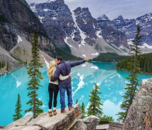 couple kissing at lake morraine in banff cananda