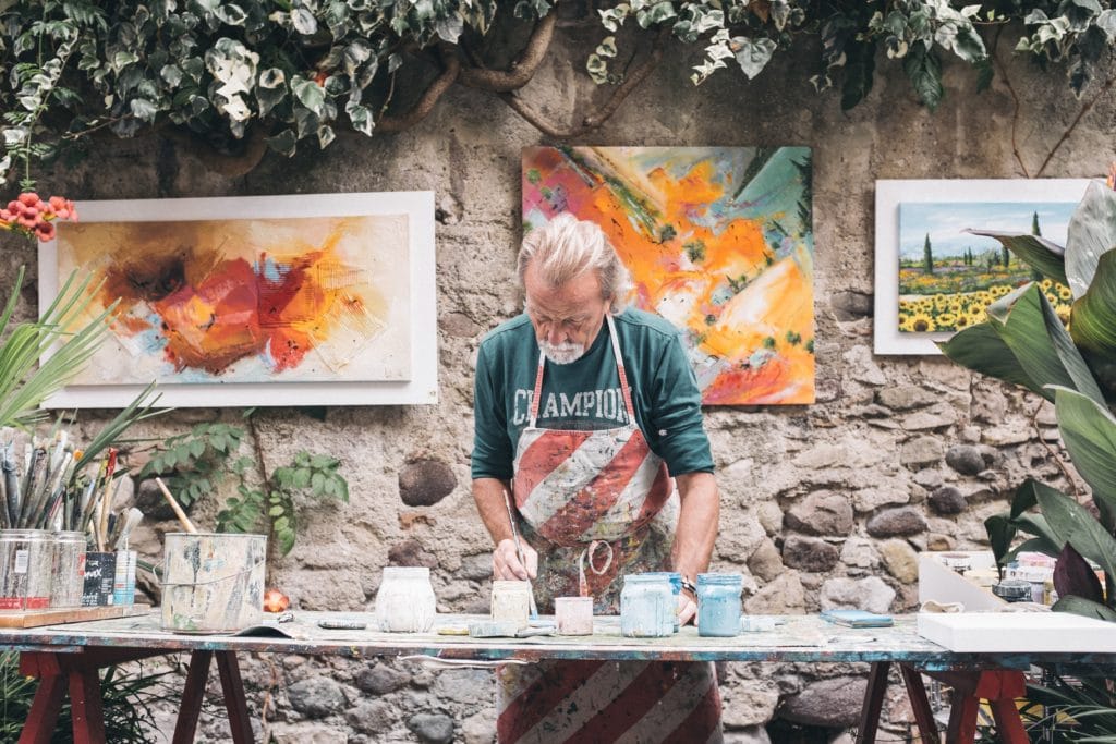 craftsman working on pottery and paintings