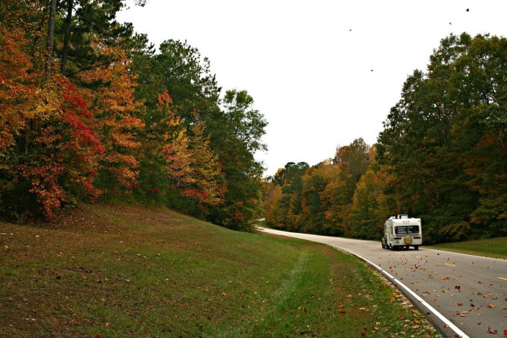 RV driving on road with fall folliage