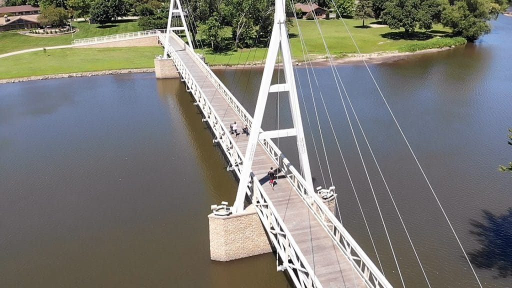 drone shot of the charles city suspension bridge