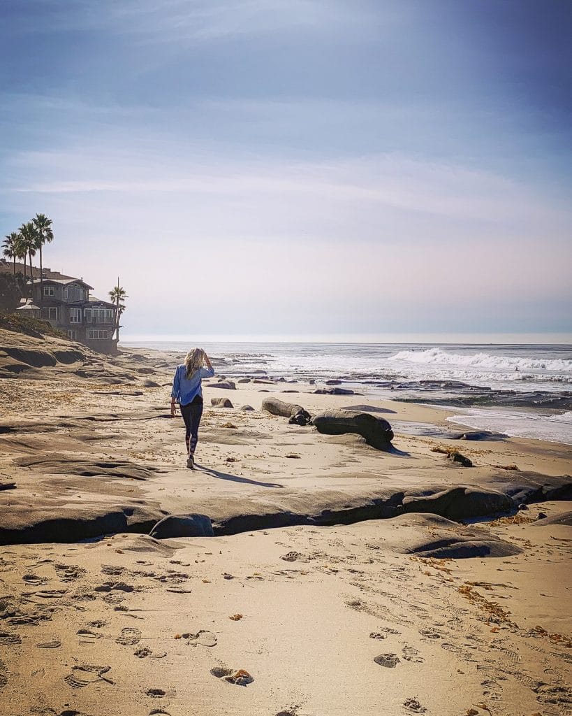 woman walking on beach in san diego california