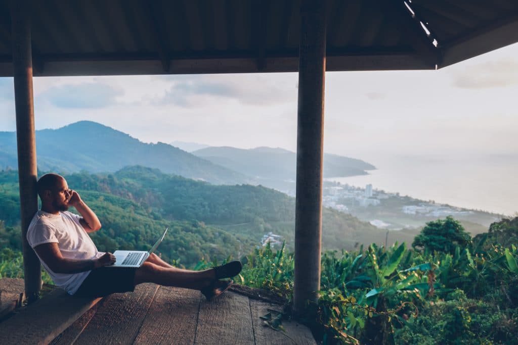 Man working remotely overlooking beautiful scenery