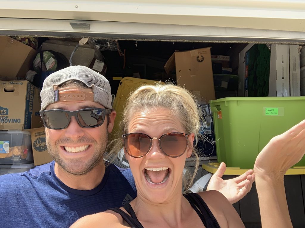 Couple overwhelmed by boxes in storage unit