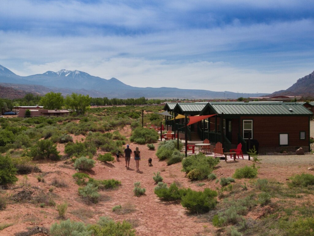 Our daily walk behind the campground couple walking dogs at KOA moab campground